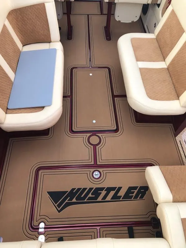 Slide: The Image of 2025 Hustler 39 Shotgun boat interior with custom flooring and seating. - 14