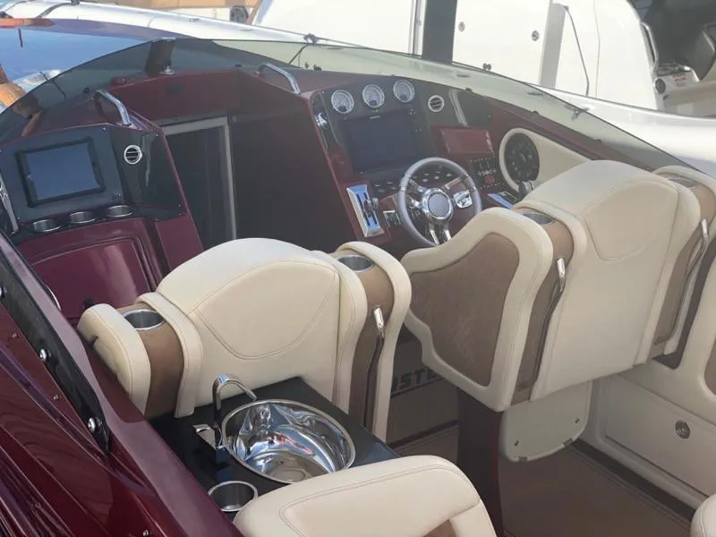 Slide: The Image of Interior cockpit of 2025 Hustler 39 Shotgun boat with modern controls and beige seats. - 15