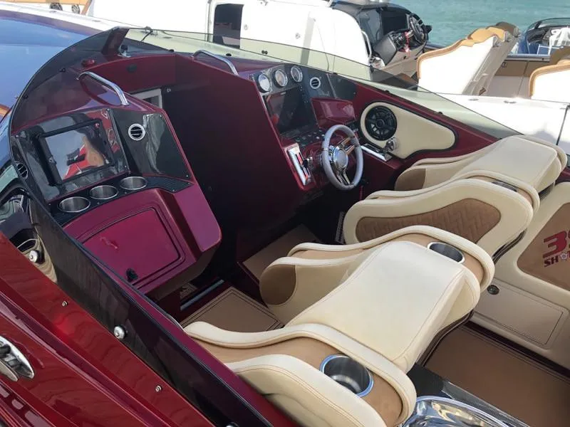 Slide: The Image of 2025 Hustler 39 Shotgun boat interior with luxurious seating and advanced dashboard. - 16