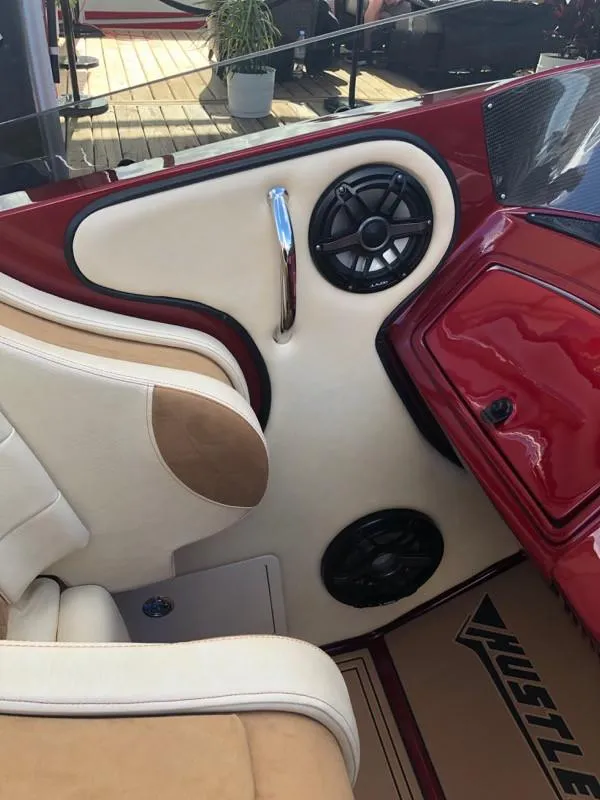 Slide: The Image of Interior of 2025 Hustler 39 Shotgun boat with beige and red upholstery. - 17