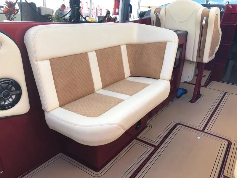 Slide: The Image of Luxurious seating on the 2025 Hustler 39 Shotgun boat with beige and tan upholstery. - 18