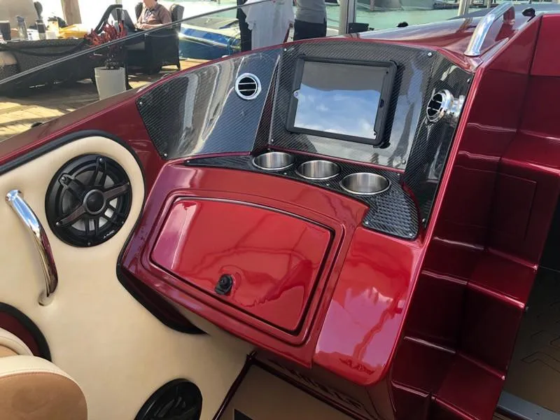 Slide: The Image of 2025 Hustler 39 Shotgun boat dashboard with touchscreen, cup holders, and speakers. - 20