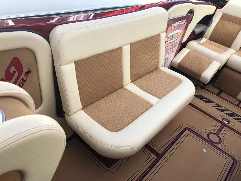 Slide: The Image of Hustler 39 Shotgun 2025 boat interior with beige and brown leather seats. - 24
