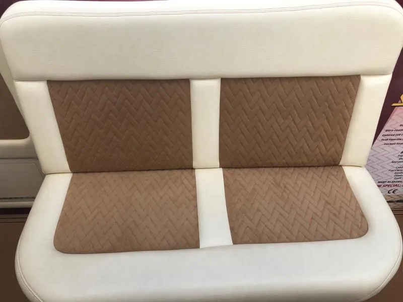 Slide: The Image of 2025 Hustler 39 Shotgun boat seat with beige and white upholstery. - 25