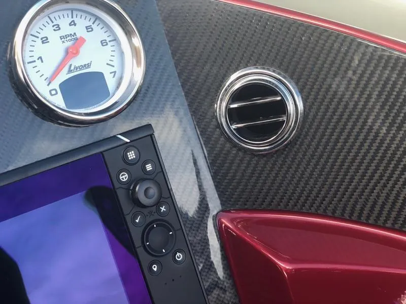 Slide: The Image of Close-up of 2025 Hustler 39 Shotgun dashboard with RPM gauge and control panel. - 5