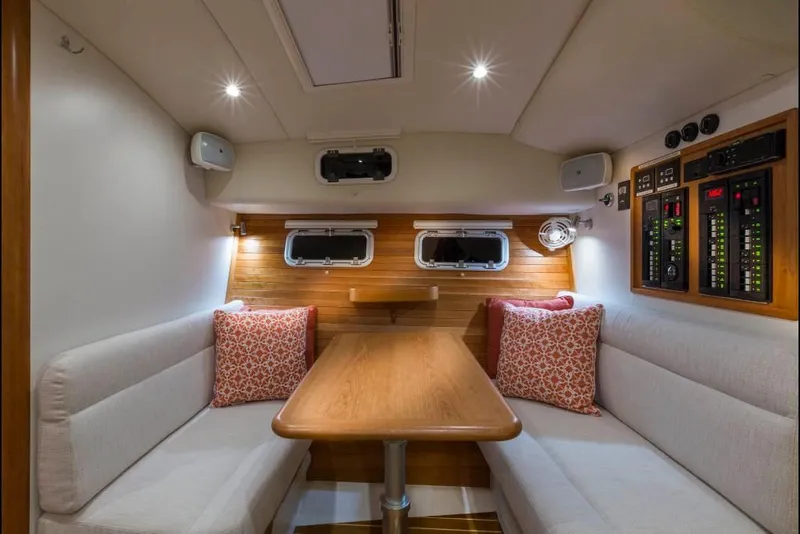 Slide: The Image of Interior of 2023 MJM 43z yacht with cozy dining area and control panel. - 10