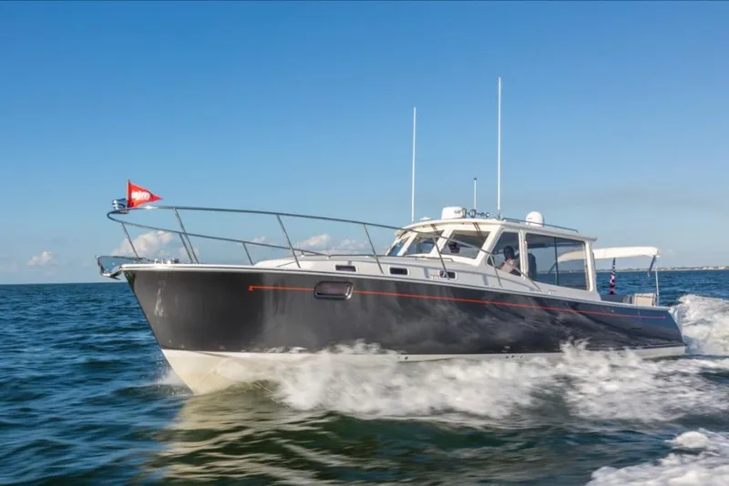 Slide: The Image of 2023 MJM 43z boat cruising on open water. - 2