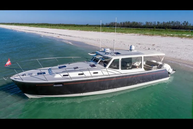 Slide: The Image of 2023 MJM 43z yacht anchored near a sandy beach. - 4