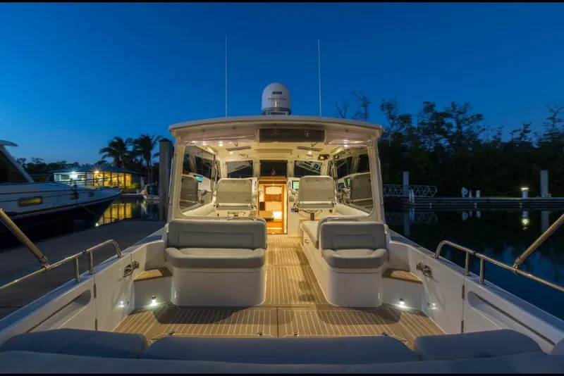 Slide: The Image of 2023 MJM 43z luxury yacht at dusk, featuring spacious seating and modern amenities. - 6