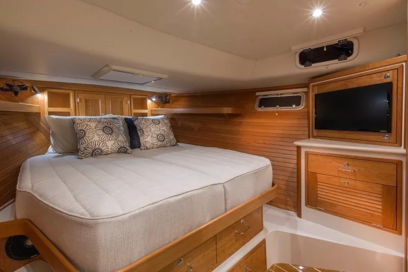 Slide: The Image of Luxurious cabin interior of 2023 MJM 43z yacht with bed, TV, and wooden cabinetry. - 7