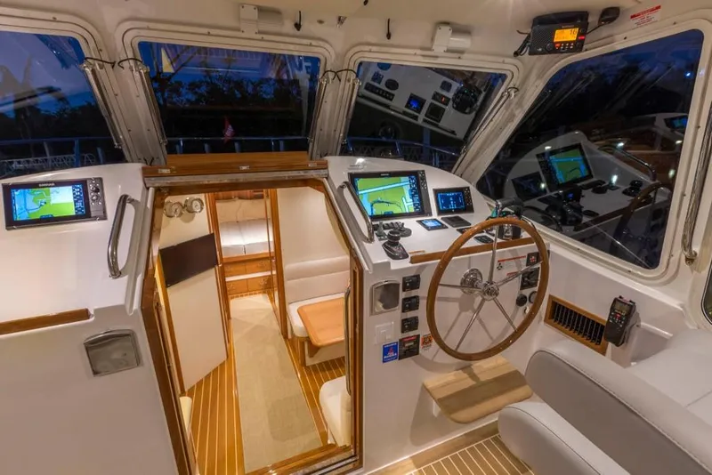 Slide: The Image of Interior cockpit of 2023 MJM 43z boat with navigation equipment and wooden accents. - 8