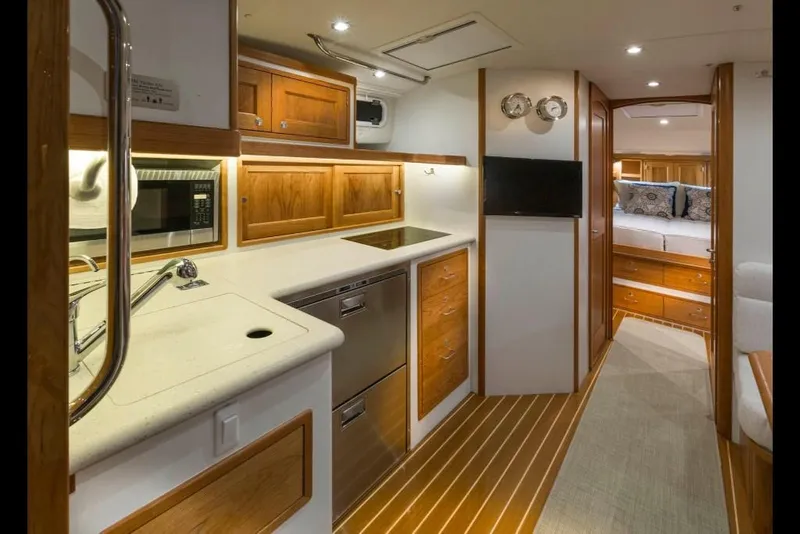 Slide: The Image of 2023 MJM 43z yacht interior with modern kitchen and cozy bedroom. - 9