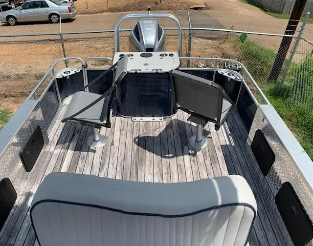 Slide: The Image of 2019 Angler Qwest 824 Crappie Edition boat interior with fishing seats and motor. - 3