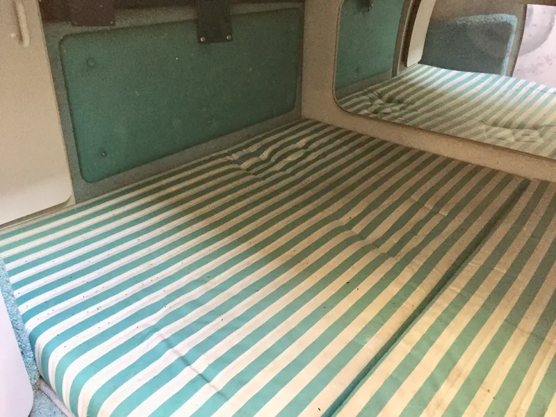 Slide: The Image of Interior cabin of 1993 Regal 300 Commodore with striped bedding and mirror. - 10