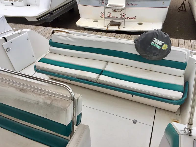 Slide: The Image of 1993 Regal 300 Commodore boat interior with teal and white seating. - 2