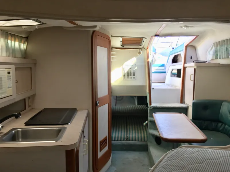 Slide: The Image of Interior of 1993 Regal 300 Commodore boat with kitchenette and seating area. - 6