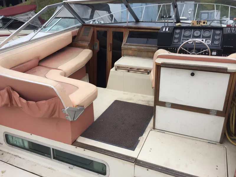 Slide: The Image of 1981 Bayliner 3250 Conquest Sunbridge boat interior with seating and control panel. - 3