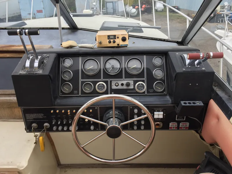Slide: The Image of Cockpit of 1981 Bayliner 3250 Conquest Sunbridge with steering wheel and control panel. - 4