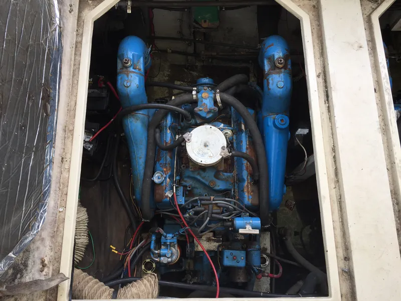 Slide: The Image of Engine compartment of 1981 Bayliner 3250 Conquest Sunbridge with visible blue engine components. - 5