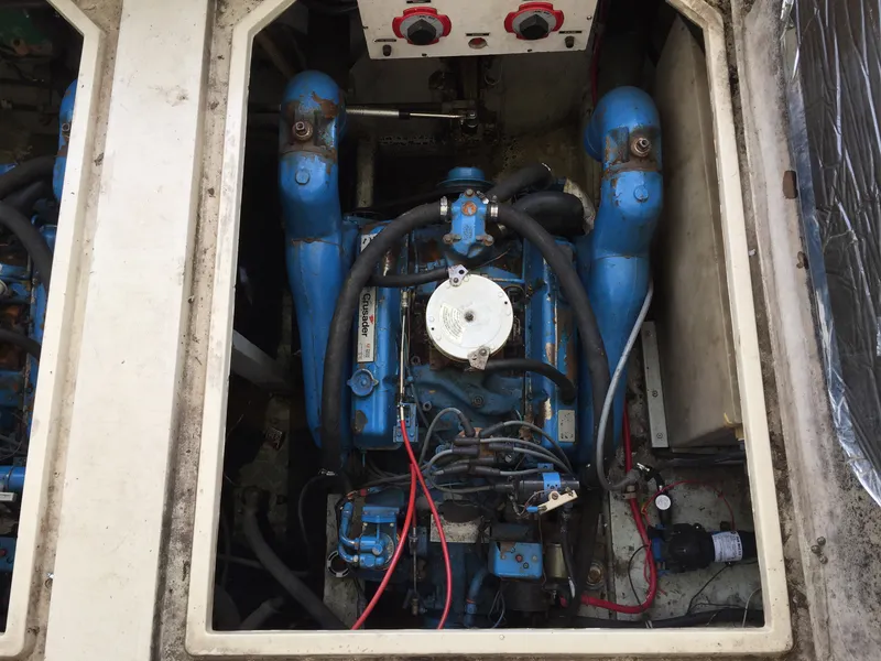 Slide: The Image of Engine compartment of 1981 Bayliner 3250 Conquest Sunbridge, featuring a blue marine engine. - 6