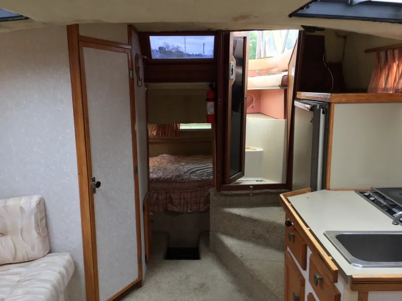Slide: The Image of Interior of 1981 Bayliner 3250 Conquest Sunbridge, featuring kitchen and sleeping area. - 8