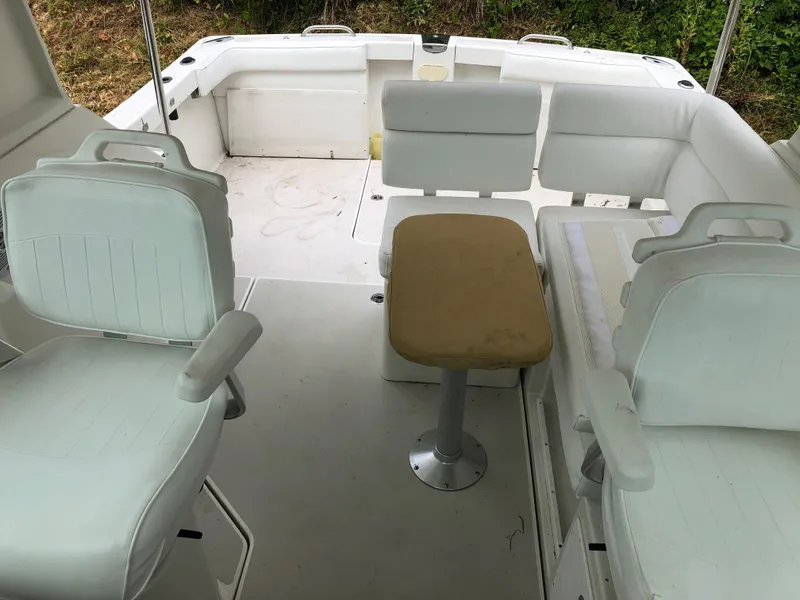 Slide: The Image of 2008 Back Cove 29 boat interior with white seating and a central table. - 10