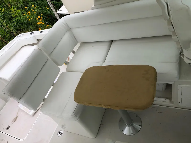 Slide: The Image of 2008 Back Cove 29 boat interior with white seating and a small table. - 11