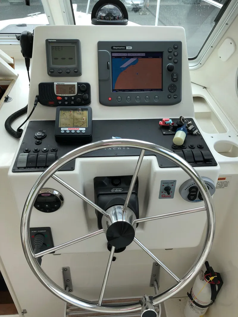 Slide: The Image of 2008 Back Cove 29 helm with navigation equipment and steering wheel. - 13