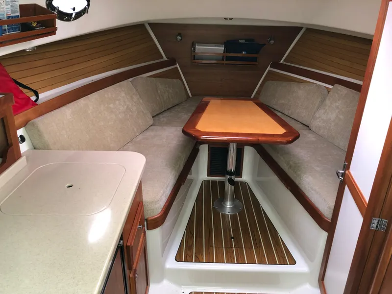 Slide: The Image of 2008 Back Cove 29 interior with cozy seating and wooden table. - 15