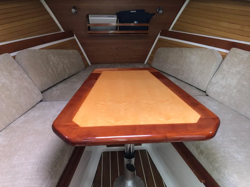 Slide: The Image of Interior of 2008 Back Cove 29 boat with wooden table and cushioned seating. - 16