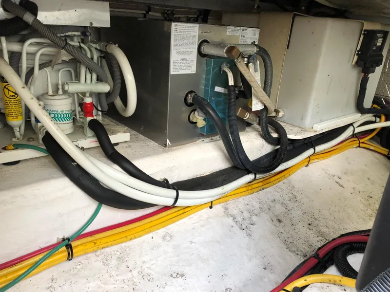 Slide: The Image of Engine compartment of a 2008 Back Cove 29 boat, showing wiring and mechanical components. - 24