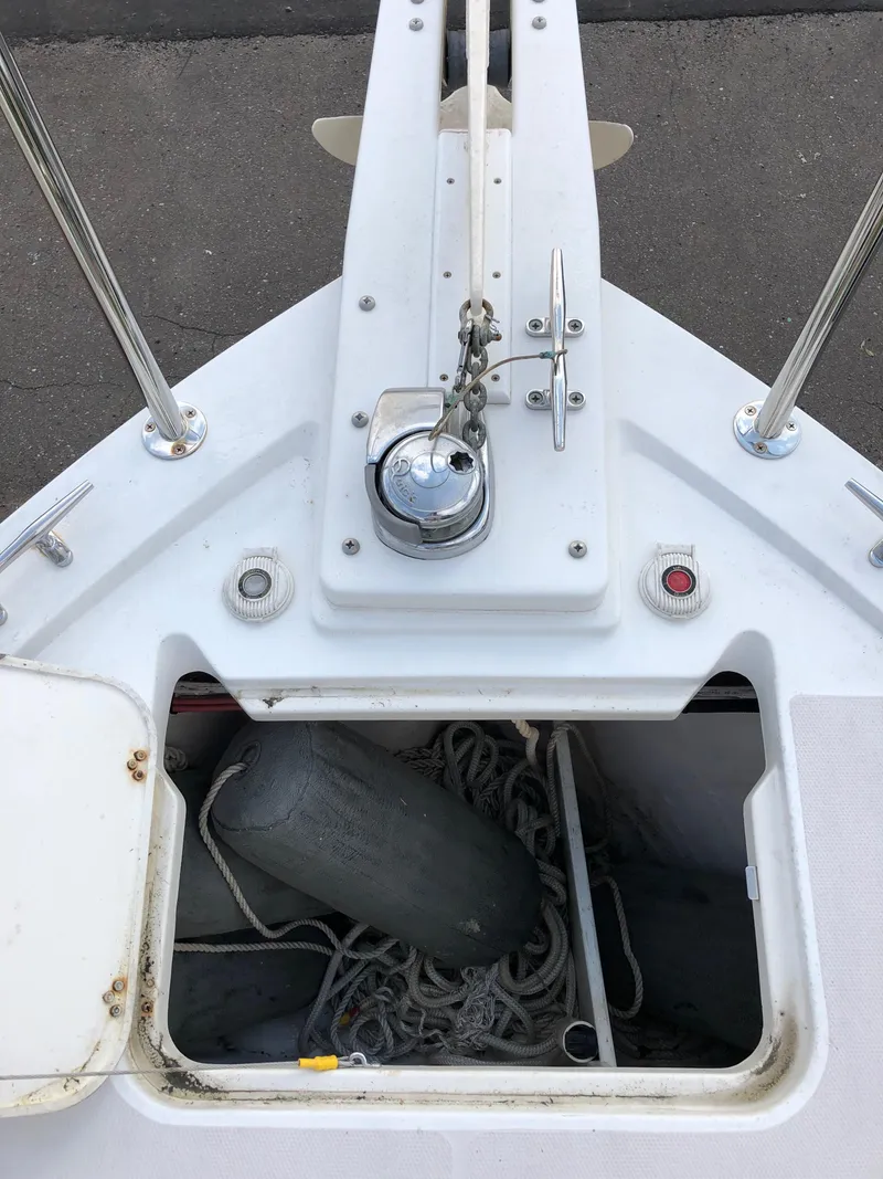 Slide: The Image of 2008 Back Cove 29 boat deck with open storage compartment and marine equipment. - 27