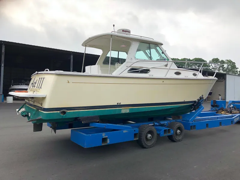 Slide: The Image of 2008 Back Cove 29 boat on trailer in a marina setting. - 5