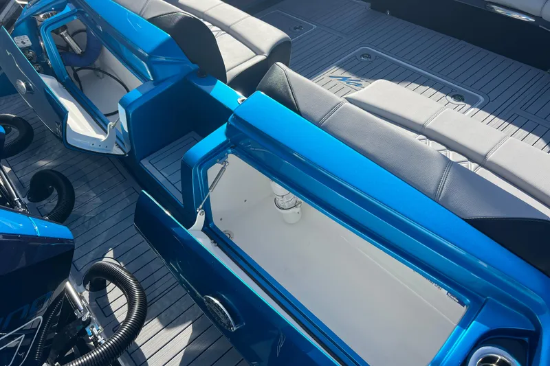 Slide: The Image of 2026 Nor-Tech 450 Sport boat interior with open storage compartments and seating. - 10
