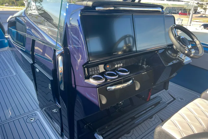 Slide: The Image of 2026 Nor-Tech 450 Sport boat cockpit with dual screens and modern steering wheel. - 13