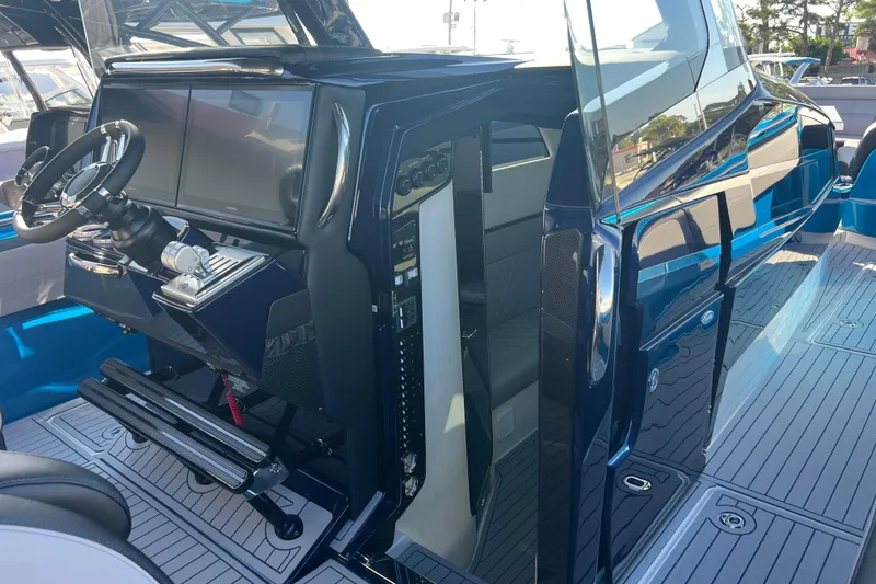 Slide: The Image of 2026 Nor-Tech 450 Sport boat cockpit with modern steering and dual screens. - 15