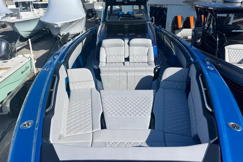 Slide: The Image of 2026 Nor-Tech 450 Sport boat with luxurious seating and sleek blue design. - 19