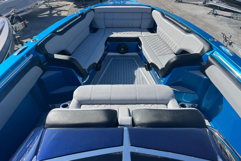 Slide: The Image of 2026 Nor-Tech 450 Sport boat interior with luxurious seating and sleek blue design. - 21