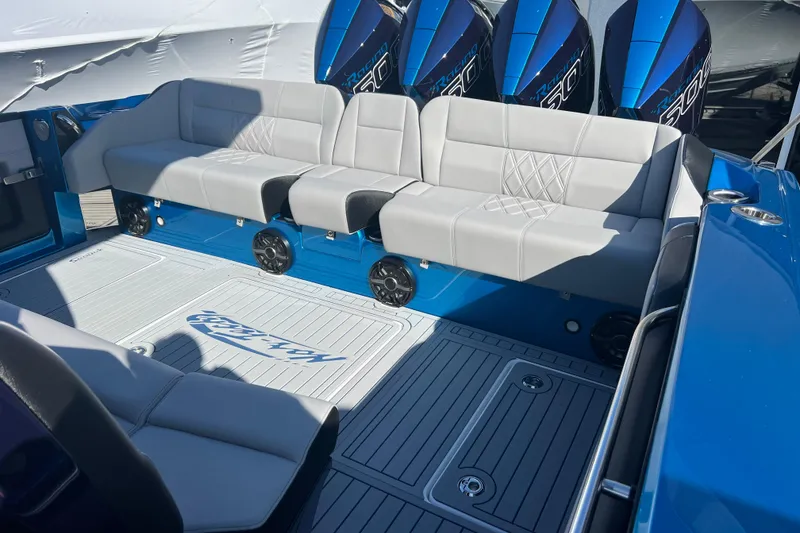 Slide: The Image of 2026 Nor-Tech 450 Sport boat interior with gray seating and blue accents. - 25