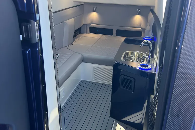 Slide: The Image of Interior of 2026 Nor-Tech 450 Sport boat with seating and kitchenette area. - 28