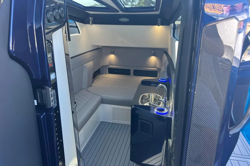 Slide: The Image of Luxurious interior of 2026 Nor-Tech 450 Sport boat with seating and sink. - 29
