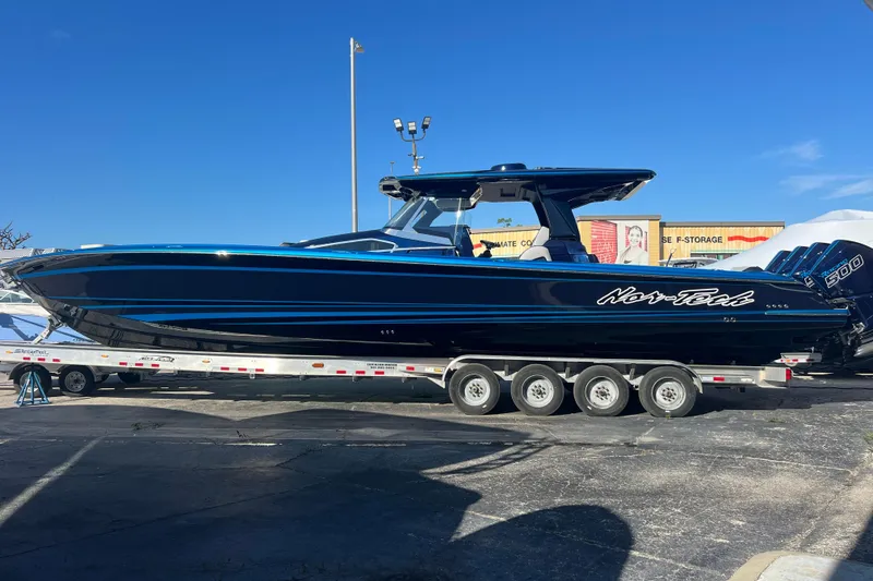 Slide: The Image of 2026 Nor-Tech 450 Sport boat on trailer, sleek design, blue accents, clear sky background. - 3