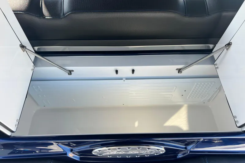 Slide: The Image of Open storage compartment in 2026 Nor-Tech 450 Sport boat, featuring sleek design and hydraulic supports. - 34