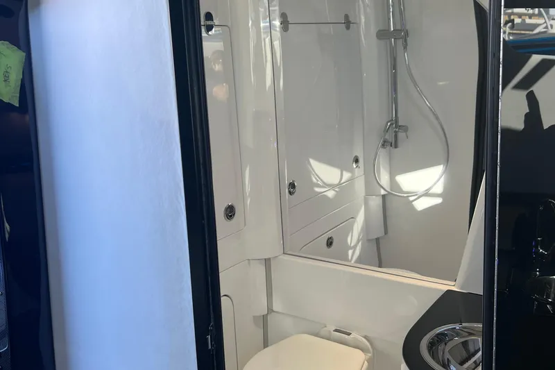 Slide: The Image of Luxurious bathroom interior of 2026 Nor-Tech 450 Sport boat, featuring modern shower and toilet. - 35