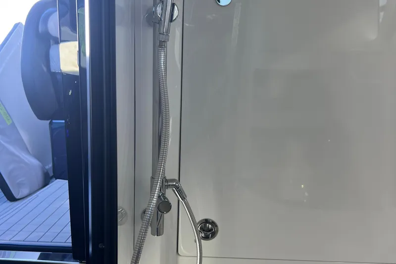 Slide: The Image of Shower area inside 2026 Nor-Tech 450 Sport boat, featuring sleek design and modern fixtures. - 36