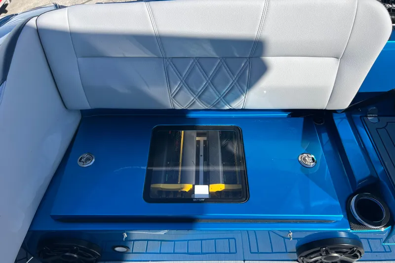 Slide: The Image of 2026 Nor-Tech 450 Sport boat interior with blue and gray seating and visible battery compartment. - 39