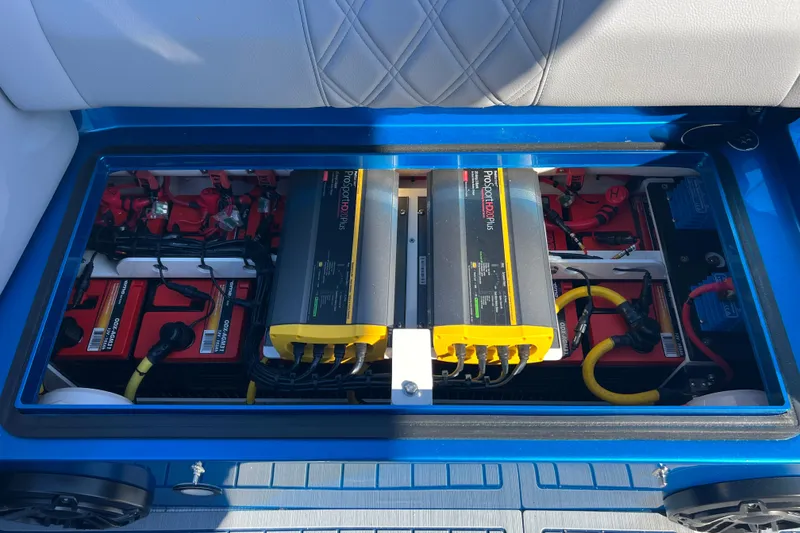 Slide: The Image of Battery compartment of 2026 Nor-Tech 450 Sport boat, featuring ProSportHD Plus chargers. - 40