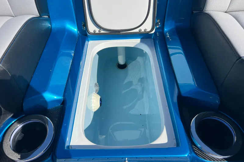 Slide: The Image of Interior view of 2026 Nor-Tech 450 Sport boat's storage compartment with cup holders. - 41