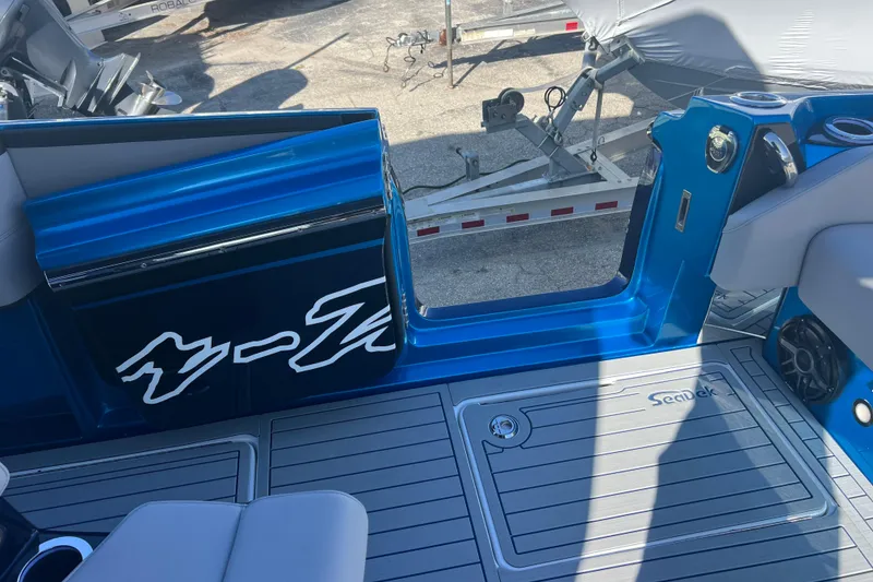 Slide: The Image of 2026 Nor-Tech 450 Sport boat interior with blue accents and SeaDek flooring. - 49