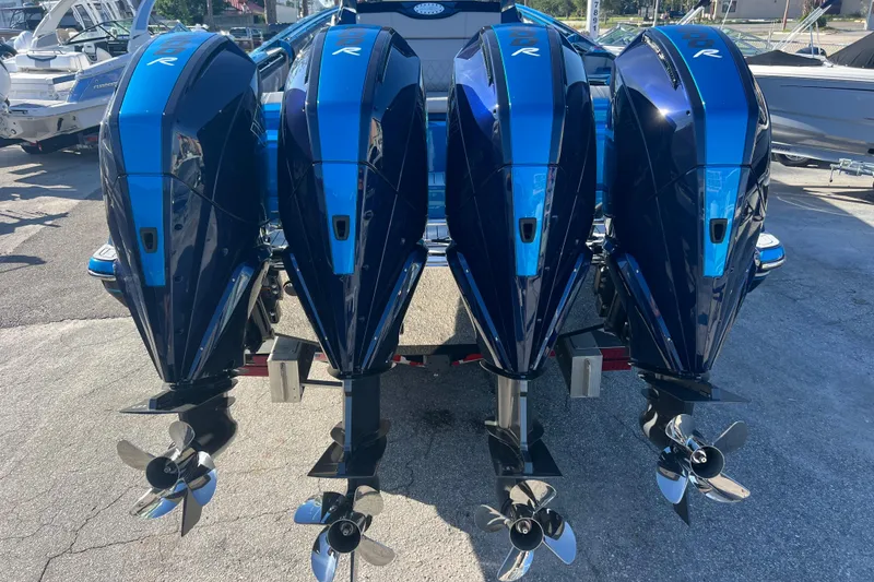 Slide: The Image of Four powerful outboard motors on a 2026 Nor-Tech 450 Sport boat. - 6